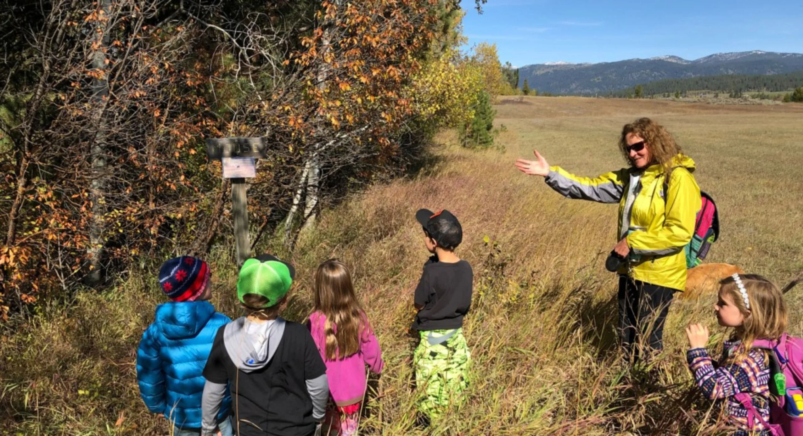Children walking a fence line on conserved pasture.